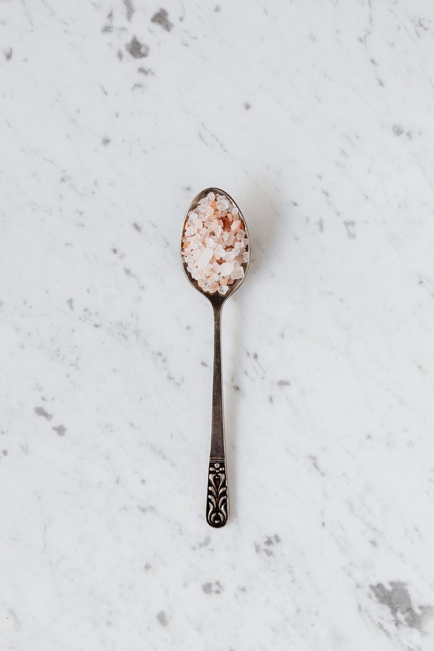 spoon with salt and spices on table
