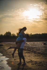 hugging couple beside seashore