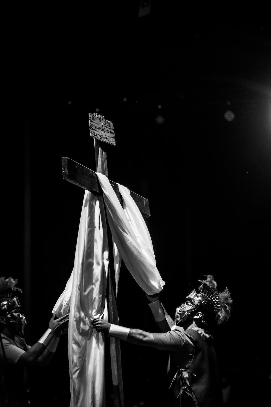 soldiers putting a fabric on a crucifix