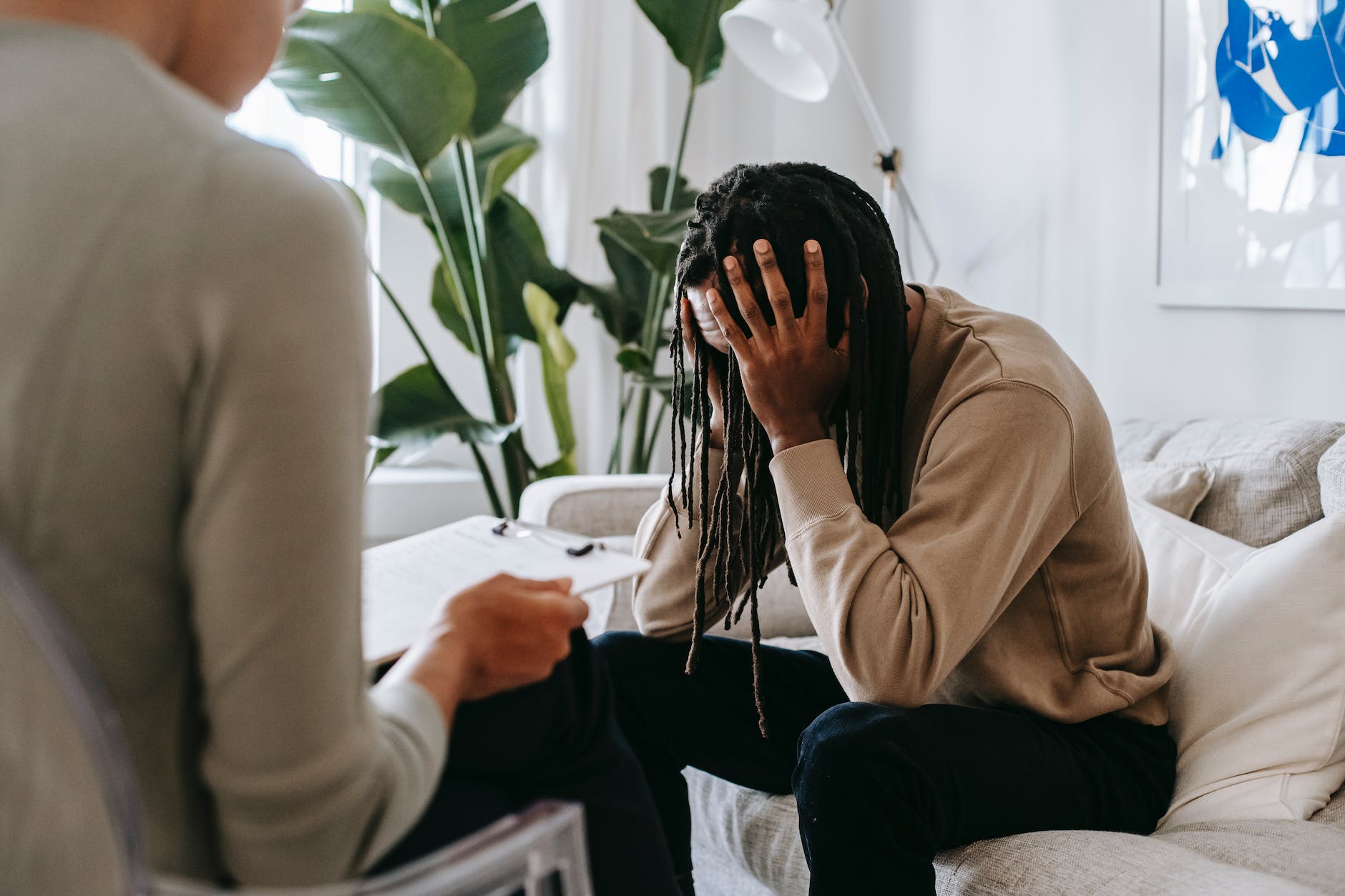 stressed black man with dreadlocks in psychological office