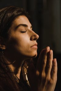 close up shot of a woman praying