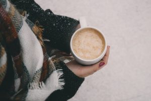 person holding mug of coffee