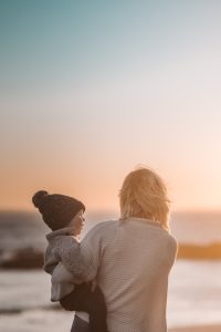 photo of woman carrying child