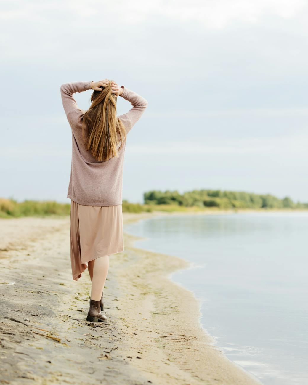 woman walking on a lakeshore