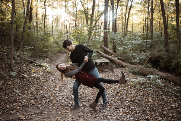man and woman dancing in forest